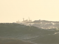 Ship plowing through stormy sea off mendocino coastline